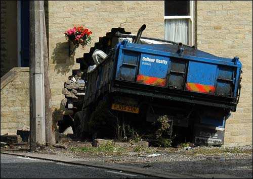 Lorry ploughs into house